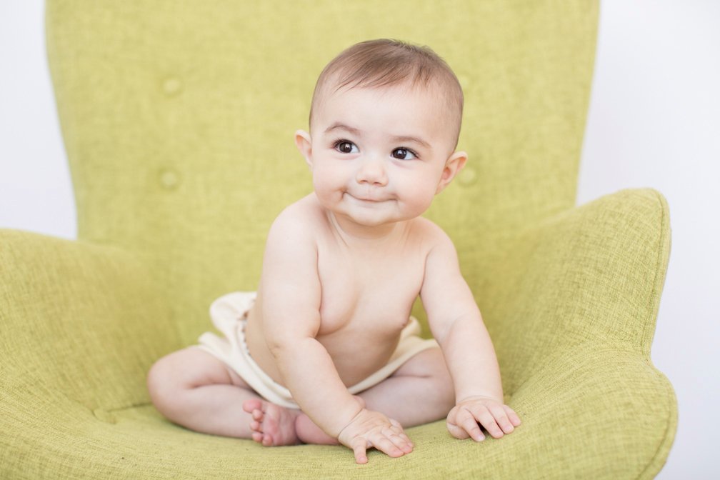 Baby portrait on a green mid-century chair